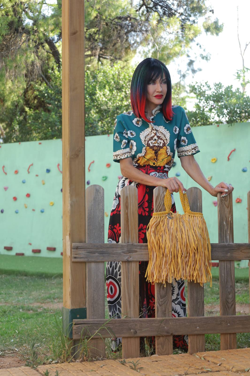 Teal floral shirt and printed skirt with fringed bag