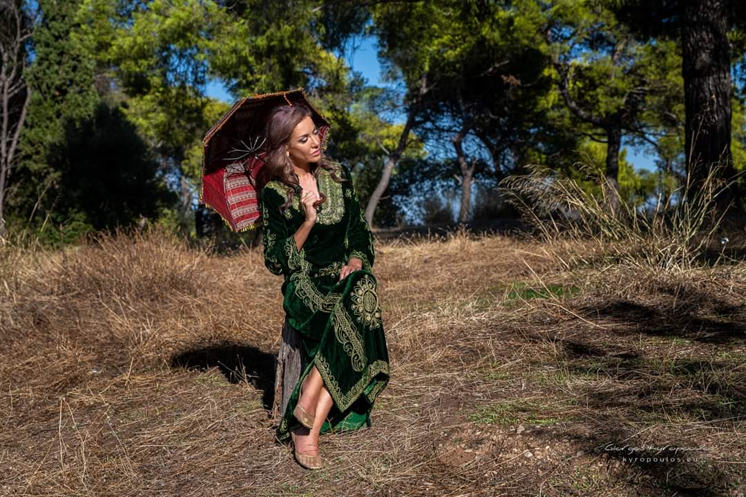 Emerald embroidered velvet gown with a vintage parasol