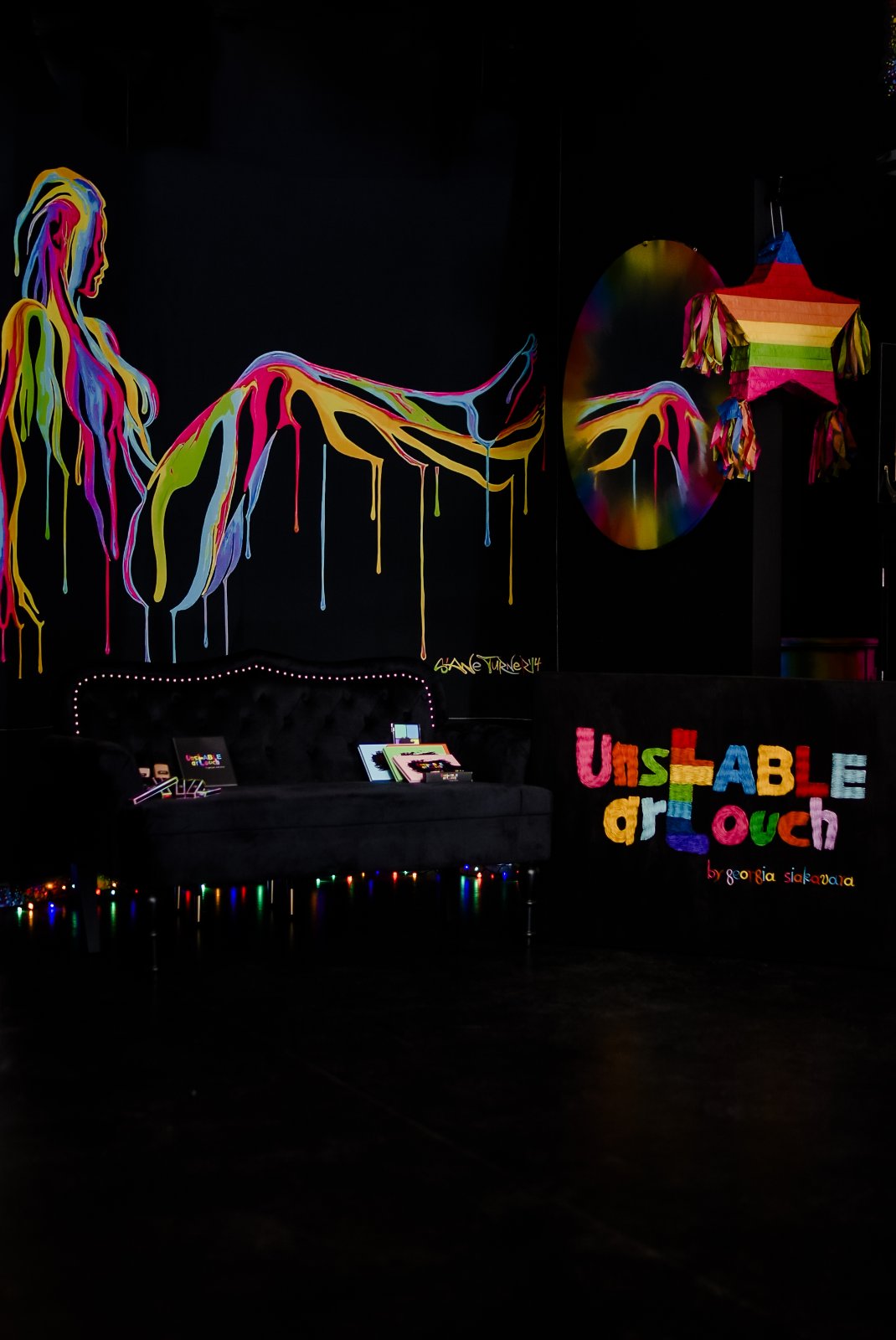 UNSTABLE ARTOUCH studio lounge with velvet sofa and fairy lights